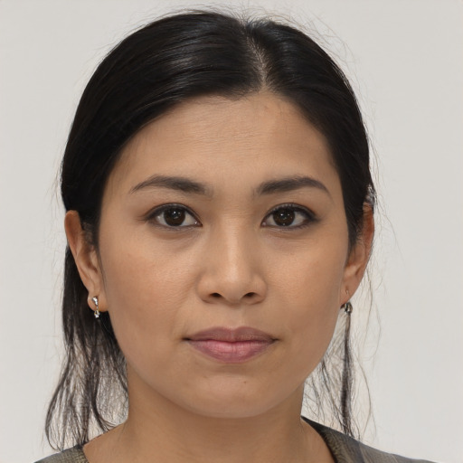 Joyful asian young-adult female with medium  brown hair and brown eyes