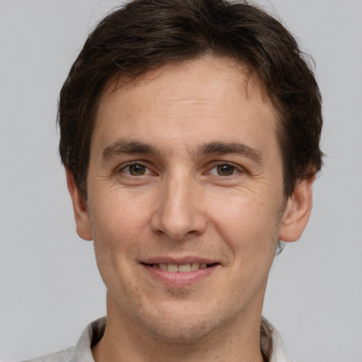 Joyful white adult male with short  brown hair and brown eyes