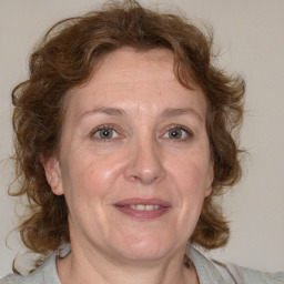 Joyful white adult female with medium  brown hair and blue eyes