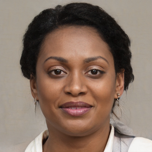 Joyful black young-adult female with medium  brown hair and brown eyes