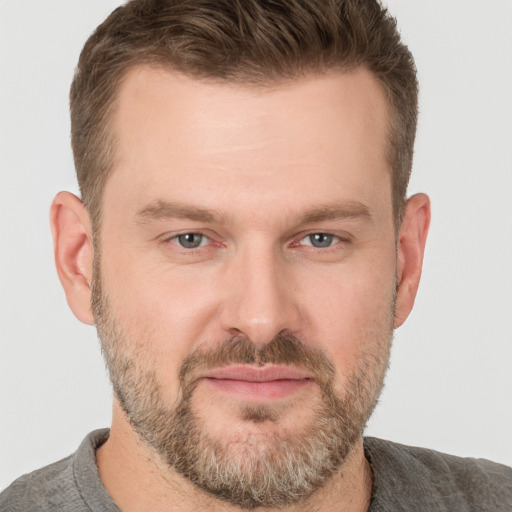 Joyful white adult male with short  brown hair and grey eyes