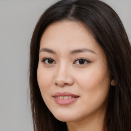 Joyful asian young-adult female with long  brown hair and brown eyes