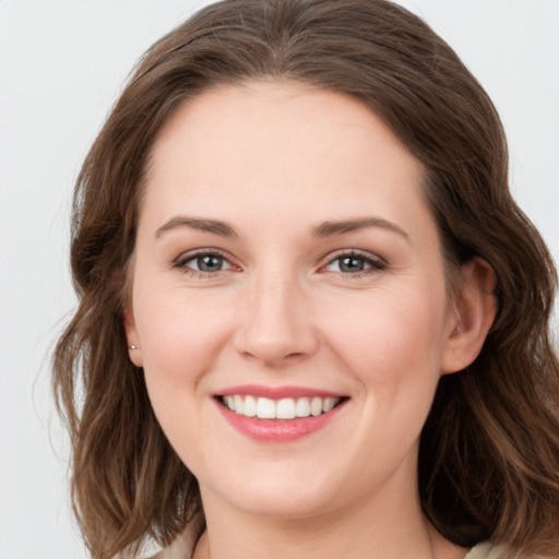 Joyful white young-adult female with long  brown hair and green eyes