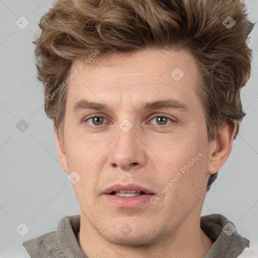 Joyful white adult male with short  brown hair and grey eyes