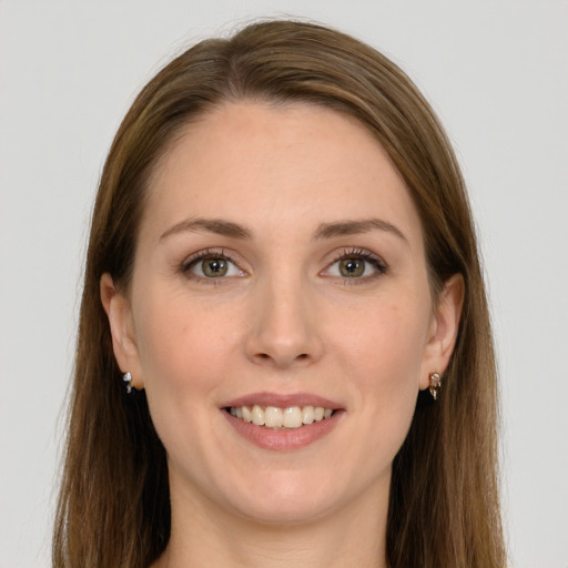 Joyful white young-adult female with long  brown hair and grey eyes