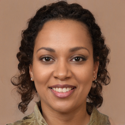 Joyful black young-adult female with long  brown hair and brown eyes