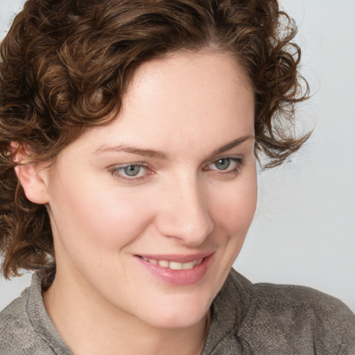 Joyful white young-adult female with medium  brown hair and blue eyes