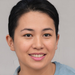 Joyful asian young-adult female with short  brown hair and brown eyes