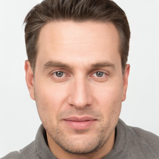 Joyful white adult male with short  brown hair and grey eyes