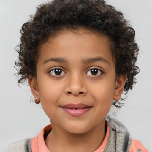 Joyful latino child female with short  brown hair and brown eyes