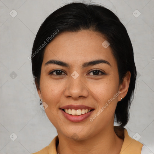 Joyful latino young-adult female with medium  brown hair and brown eyes