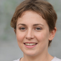 Joyful white young-adult female with medium  brown hair and green eyes