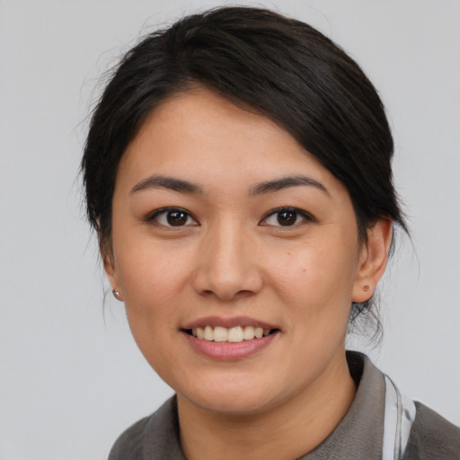 Joyful asian young-adult female with medium  black hair and brown eyes