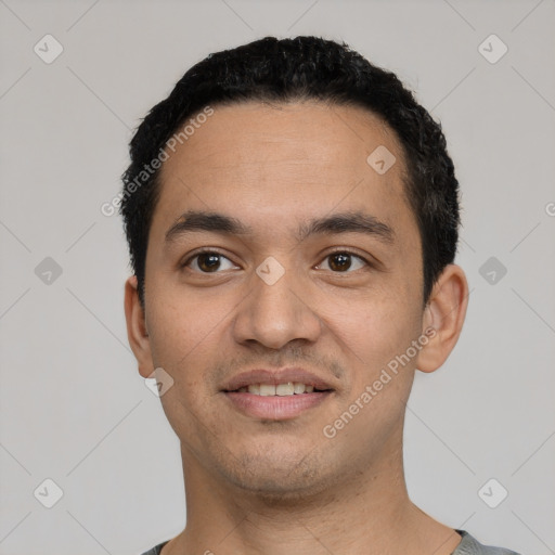 Joyful latino young-adult male with short  black hair and brown eyes