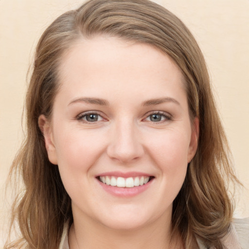 Joyful white young-adult female with long  brown hair and brown eyes