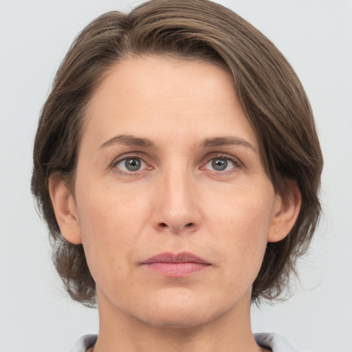 Neutral white adult female with medium  brown hair and grey eyes