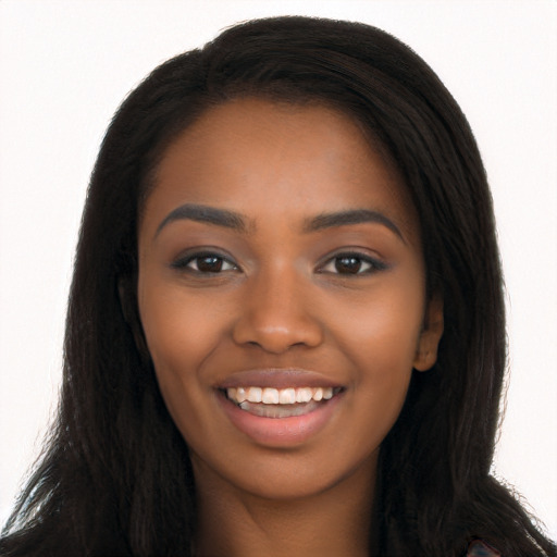 Joyful black young-adult female with long  brown hair and brown eyes