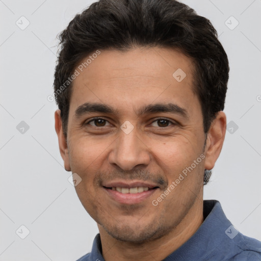 Joyful white adult male with short  black hair and brown eyes