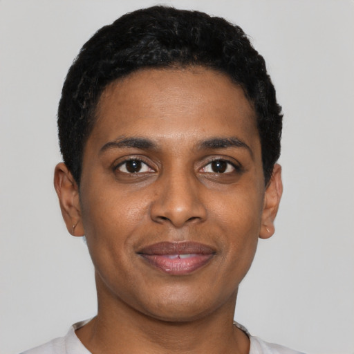 Joyful black young-adult male with short  black hair and brown eyes