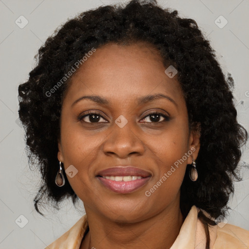 Joyful black adult female with long  brown hair and brown eyes