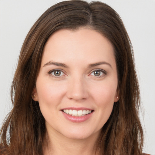 Joyful white young-adult female with long  brown hair and brown eyes