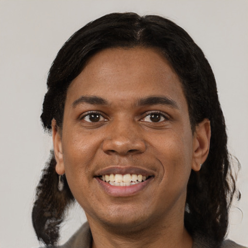 Joyful black adult male with medium  black hair and brown eyes