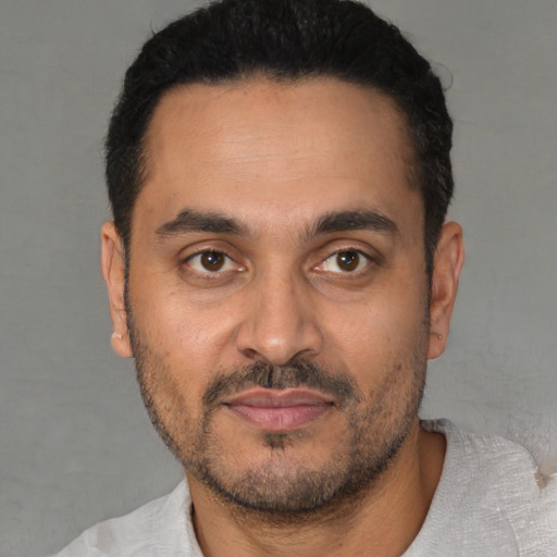 Neutral latino young-adult male with short  black hair and brown eyes