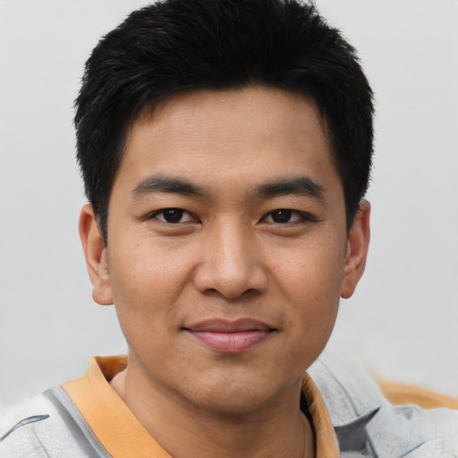 Joyful asian young-adult male with short  brown hair and brown eyes