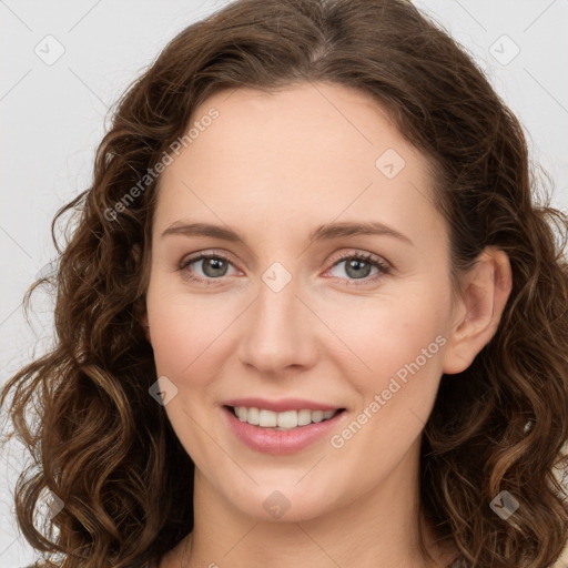 Joyful white young-adult female with long  brown hair and green eyes