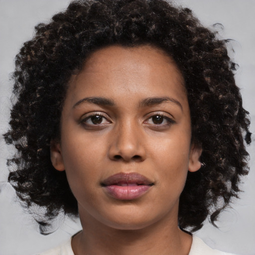 Neutral black young-adult female with medium  brown hair and brown eyes