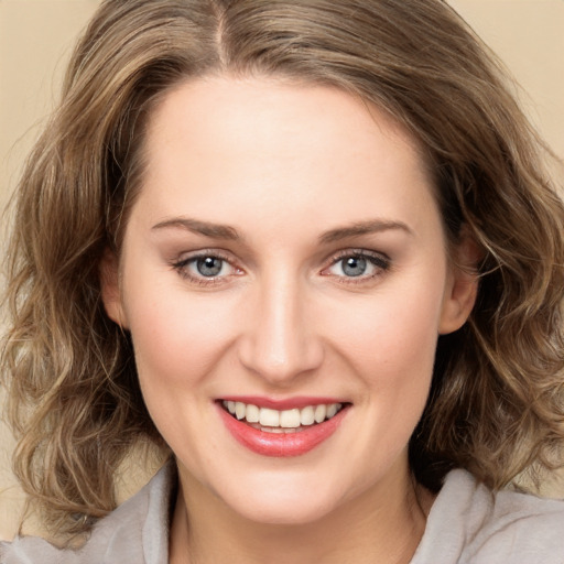 Joyful white young-adult female with medium  brown hair and green eyes