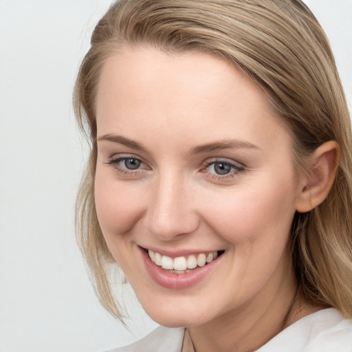 Joyful white young-adult female with medium  brown hair and blue eyes