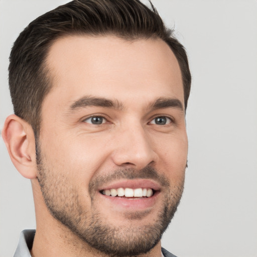 Joyful white young-adult male with short  brown hair and brown eyes