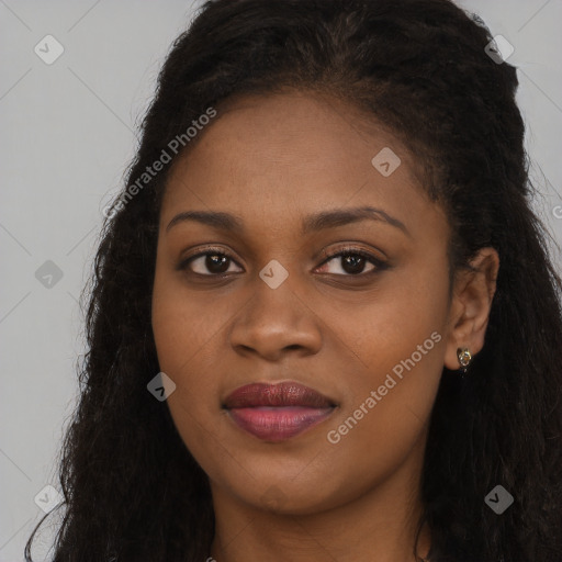 Joyful black young-adult female with long  brown hair and brown eyes