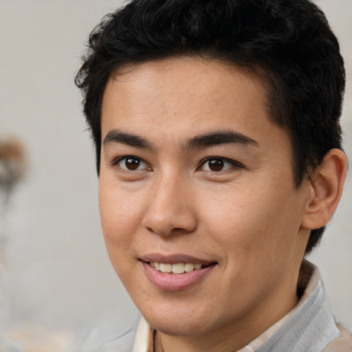 Joyful latino young-adult male with short  brown hair and brown eyes