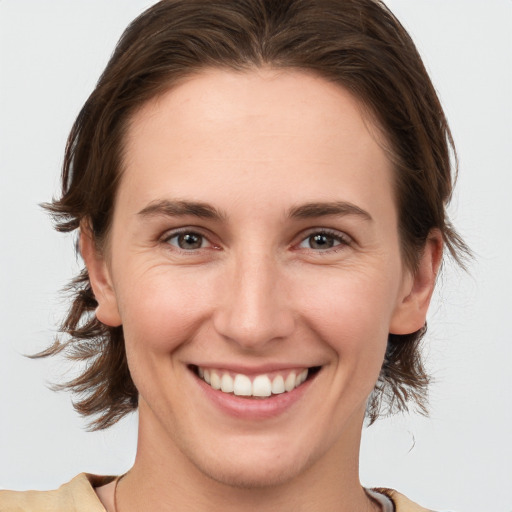 Joyful white young-adult female with medium  brown hair and brown eyes