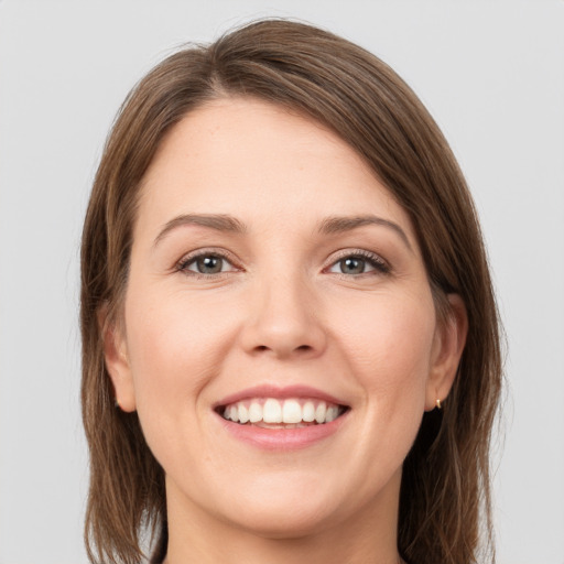 Joyful white young-adult female with long  brown hair and grey eyes