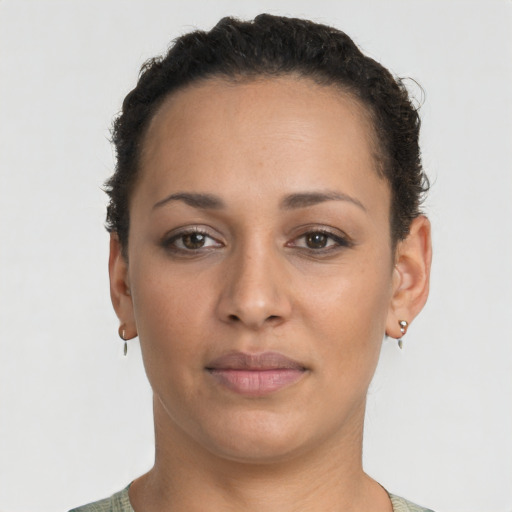 Joyful latino young-adult female with short  brown hair and brown eyes