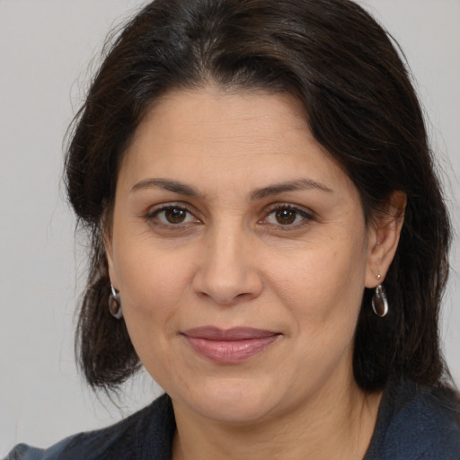 Joyful white adult female with medium  brown hair and brown eyes