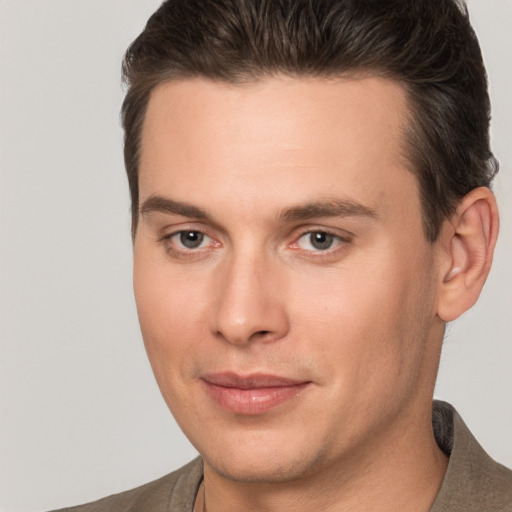 Joyful white young-adult male with short  brown hair and brown eyes