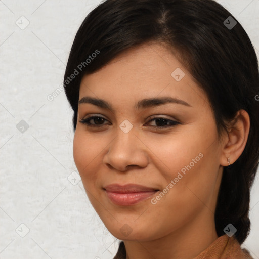 Joyful latino young-adult female with medium  brown hair and brown eyes