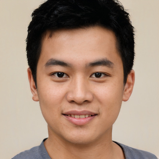 Joyful asian young-adult male with short  black hair and brown eyes