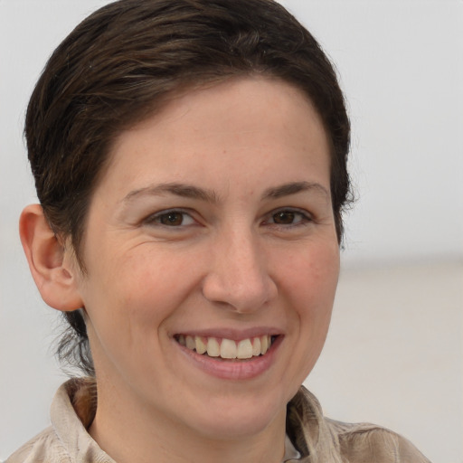 Joyful white young-adult female with medium  brown hair and brown eyes