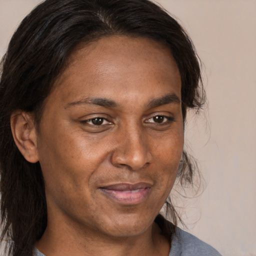Joyful black adult male with medium  brown hair and brown eyes