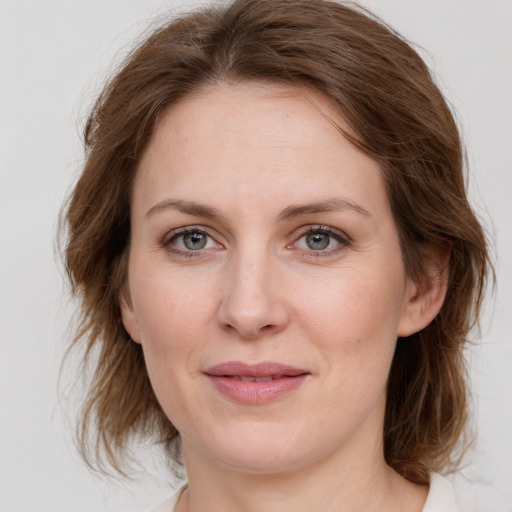 Joyful white young-adult female with medium  brown hair and green eyes