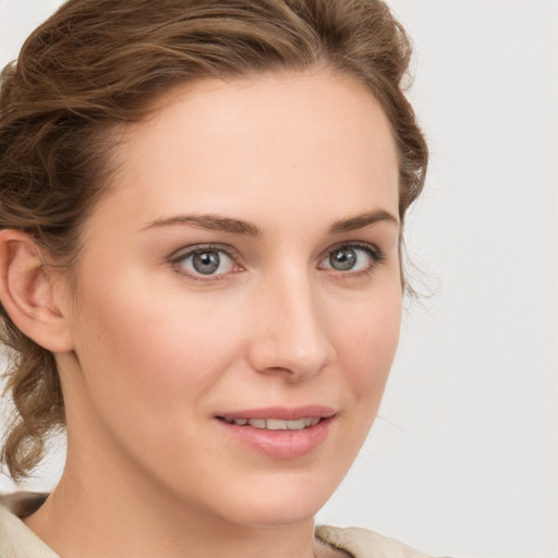 Joyful white young-adult female with medium  brown hair and green eyes