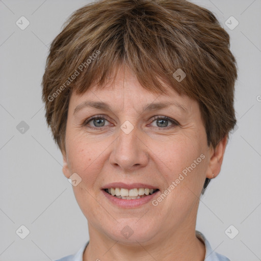 Joyful white adult female with short  brown hair and grey eyes