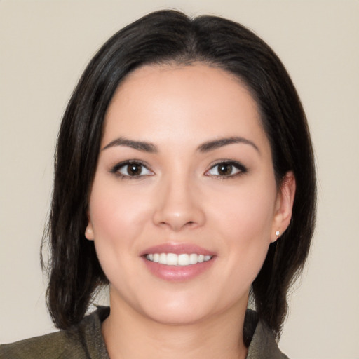 Joyful white young-adult female with medium  black hair and brown eyes