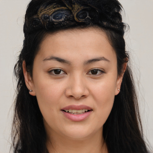 Joyful asian young-adult female with long  brown hair and brown eyes