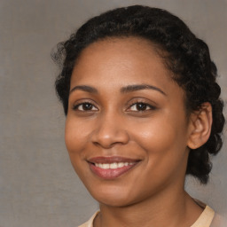 Joyful black young-adult female with medium  brown hair and brown eyes